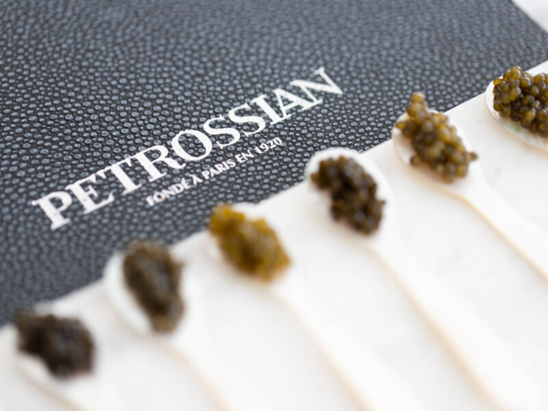 Exquisite caviar artfully arranged on ice in an elegant presentation. The delicate caviar eggs showcase a pearly sheen and a sublime texture. A refined culinary experience that evokes luxury and sophistication.