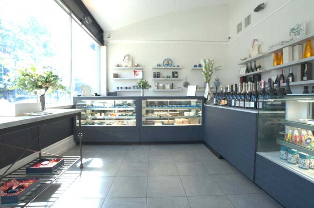 a boutique interior with refrigerated sales counters, bottles of wine, champagne and tins of caviar